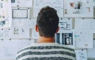 Student staring at board trying to find inspiration for project