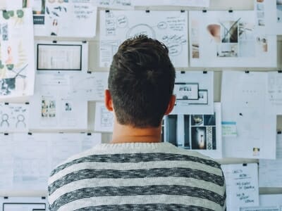 Student staring at board trying to find inspiration for project