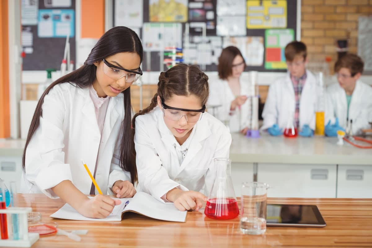 GCSE students taking measurements in an experiment